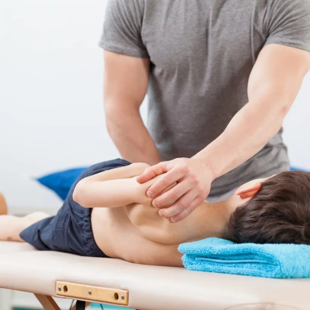 A gentle chiropractic adjustment for a child lying on a treatment table
